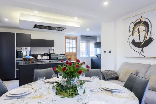 ein Esstisch mit einer Vase mit Blumen darauf in der Unterkunft Maison cosy et bien située in Colmar