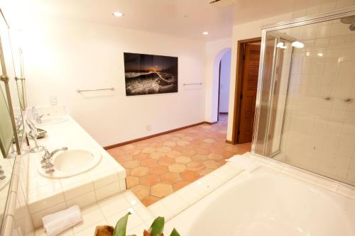a bathroom with a tub and a sink and a shower at Cliffside Villa W Ocean Views & Balcony in Avalon