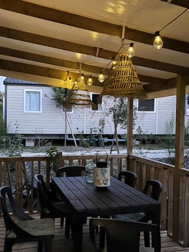 a wooden table and chairs on a patio at On est trop bien ici in Lège-Cap-Ferret