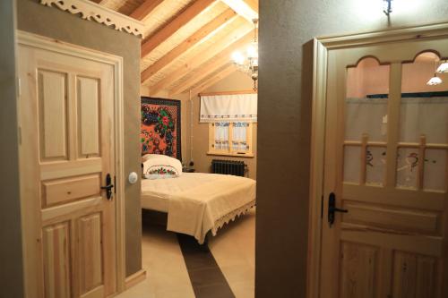 a bedroom with a bed and an open door at ECO Hotel Gagauz Sofrasi in Congaz