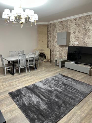 a living room with a dining table and a fireplace at Private house, Own and magnificent villa, Apartments in Yerevan