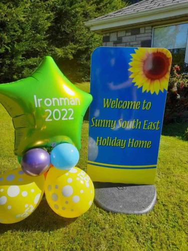 a sign for a welcome to sunny south east holiday home at Sunny South East Holiday Home in Clashmore