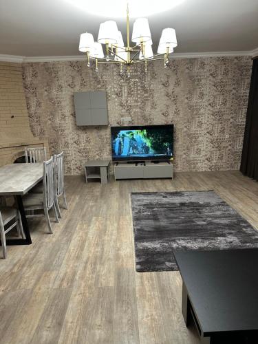 a living room with a flat screen tv and a table at Private house, Own and magnificent villa, Apartments in Yerevan