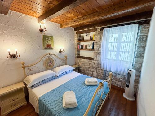 a bedroom with a blue bed in a room at City Center Coastal Escape - Apartments with Sea View or Cozy Room in Novigrad Istria
