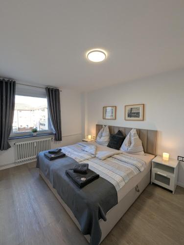 a bedroom with a large bed with two pillows at Strandappartement 2 Minuten vom Südstrand in Wilhelmshaven