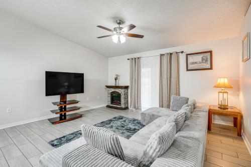 a living room with a couch and a tv at 8 Mi to Legoland Winter Haven Home with Lanai! in Winter Haven