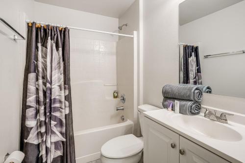 a white bathroom with a sink and a toilet at 8 Mi to Legoland Winter Haven Home with Lanai! in Winter Haven
