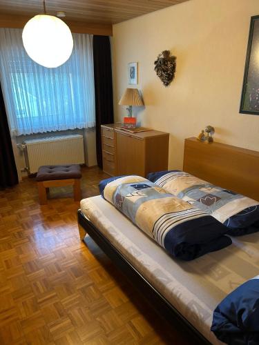 a bedroom with a large bed and a lamp at Land-Haus Sonnenhang in Lorch am Rhein