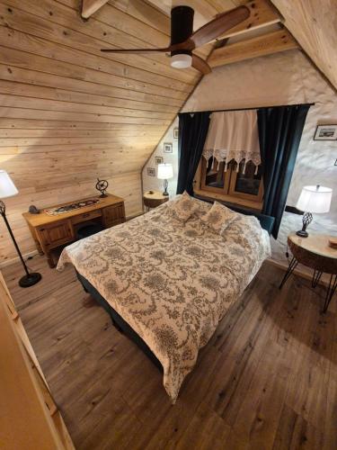 a bedroom with a bed and a ceiling fan at Woodland House 1 in Berezka