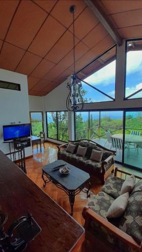 a living room with a couch and a table at Jungle Lodge Santis Panama in Bajo Grande