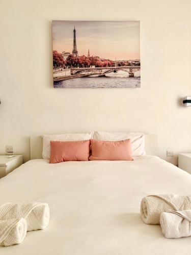 a bedroom with a bed with a picture of the eiffel tower at Pembroke Parkside Maisonette in Pembroke 