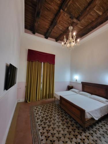 een slaapkamer met een groot bed en een kroonluchter bij Art house Venusio luxury home in Napels