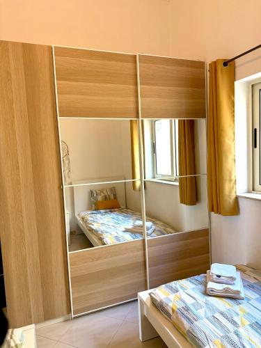 a bedroom with a mirrored cabinet with a bed in it at Pembroke Parkside Maisonette in Pembroke 