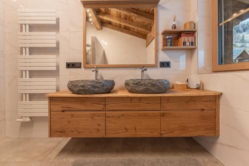 two sinks on a wooden counter in a bathroom at Walker Chalet in Rettenbach