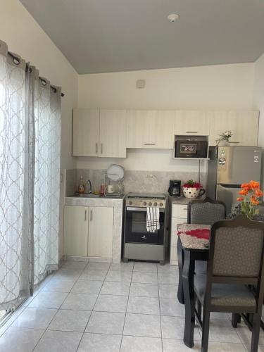 een keuken met een fornuis en een tafel met stoelen bij Casa tonykey in San Miguel