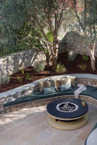 a bench with pillows on it in a garden at OD Luxury Villa in Pylos