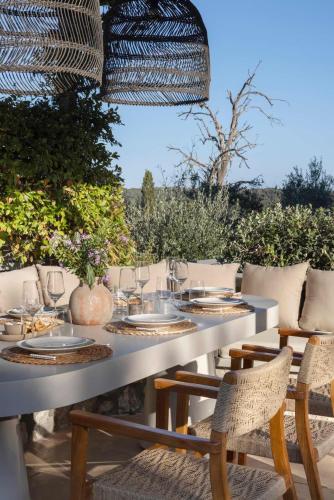 a table with glasses and chairs on a patio at OD Luxury Villa in Pylos