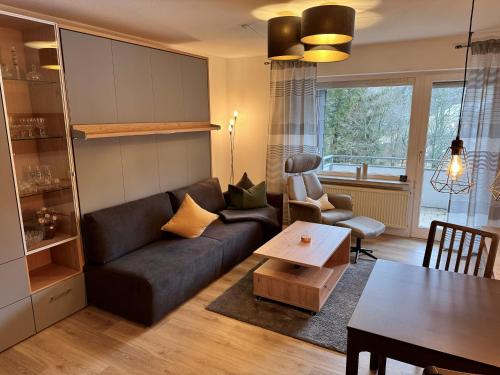 a living room with a couch and a table at Gipfelblick Apartment in Goslar