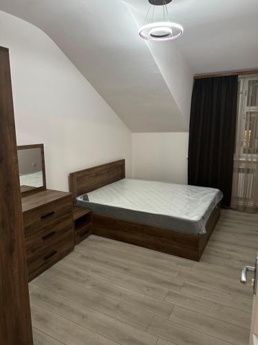 a bedroom with a bed and a mirror at Private house, Own and magnificent villa, Apartments in Yerevan