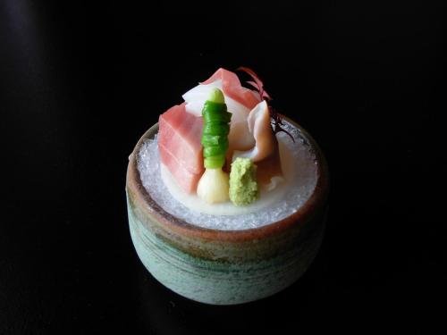 a small dessert with meat and vegetables on a table at Yoshimatsu in Hakone