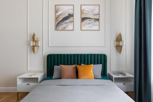 a bed with a green headboard in a bedroom at GOLDENGREEn in Sibiu