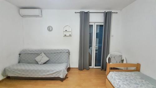 Una cama o camas en una habitación de Vojinovic Apartments