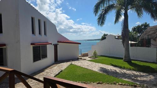 a house with a view of the water at bacalar My Love Front Laguna in Bacalar
