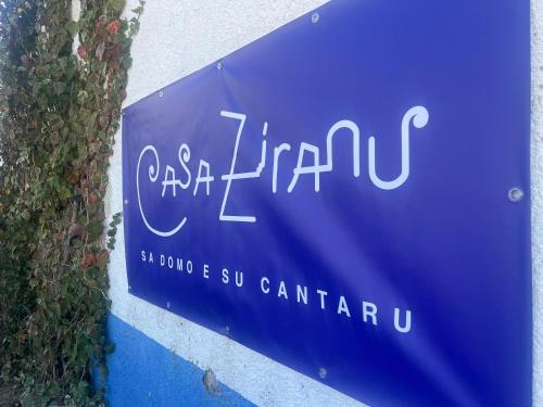a blue sign for a car dealership at Casa Ziranu Sa Domo e su Cantaru in Orani