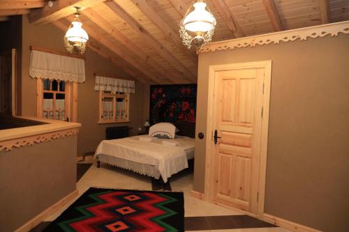 a bedroom with a bed and a chandelier at ECO Hotel Gagauz Sofrasi in Congaz