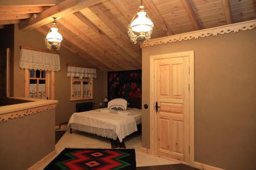 a bedroom with a bed and a ceiling with lights at ECO Hotel Gagauz Sofrasi in Congaz