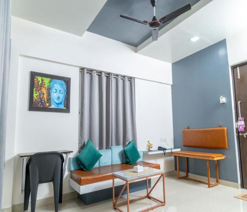 a living room with a couch and a table at Copper 11 Service Apartments -SB Road, Shivaji Nagar, Pune in Pune