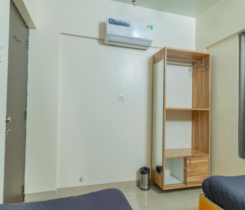 a room with a medicine cabinet and a mirror at Copper 11 Service Apartments -SB Road, Shivaji Nagar, Pune in Pune