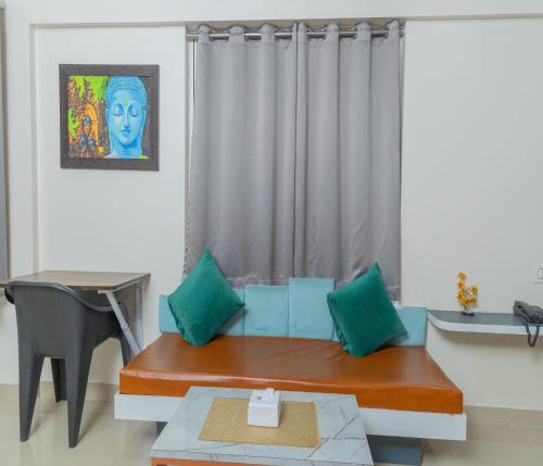 a living room with a couch and a table at Copper 11 Service Apartments -SB Road, Shivaji Nagar, Pune in Pune