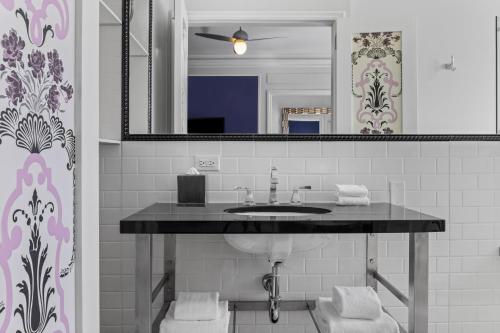 a bathroom with a sink and a mirror at Inn at the Park in San Diego