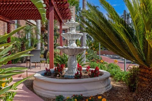a large fountain in the middle of a garden at Inn at the Park in San Diego