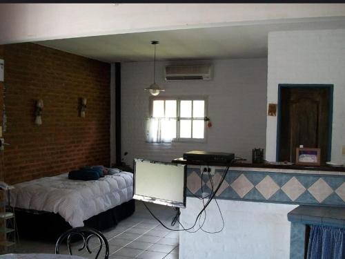 a bedroom with a bed and a table in a room at Nupalembe in Ezeiza