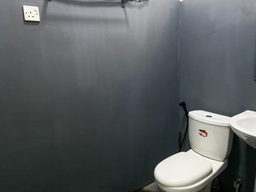 a bathroom with a white toilet and a sink at S and D Home Stay in Nuwara Eliya