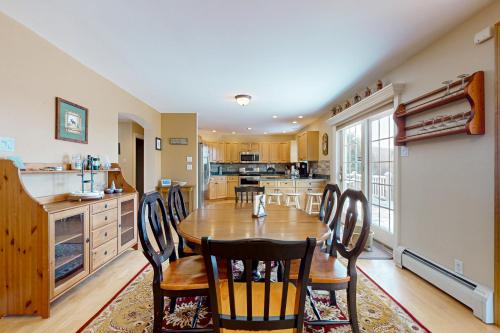 a kitchen and dining room with a table and chairs at Wish Upon A Star in Windham