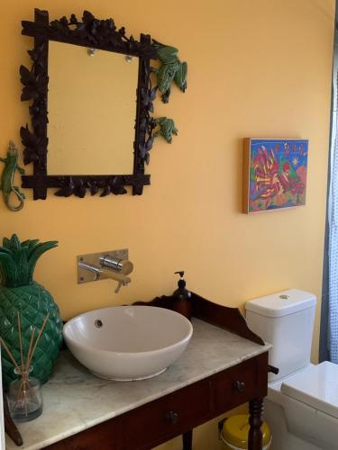 a bathroom with a sink and a mirror on the wall at Casa de Santa Margarida in Ponta Delgada