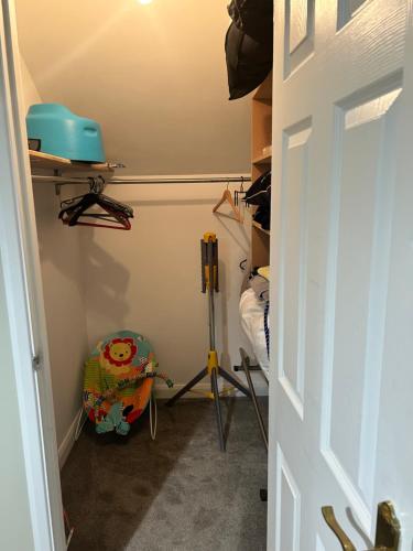 a room with a closet with a bed and a door at The Burrow in Glenoe