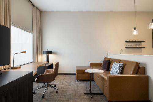 a living room with a couch and a table at Residence Inn by Marriott Mechanicsburg in Enola