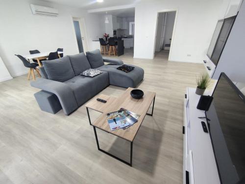 a living room with a couch and a table at Azores Blue Bay II in Madalena