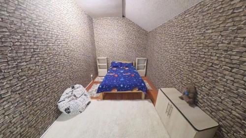 a room with a bed in a brick wall at Cabana Floare in Straja