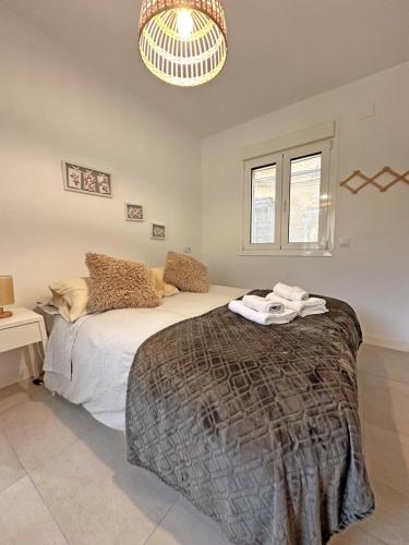 a bedroom with a large bed and a chandelier at Rayo de Luz in Toledo