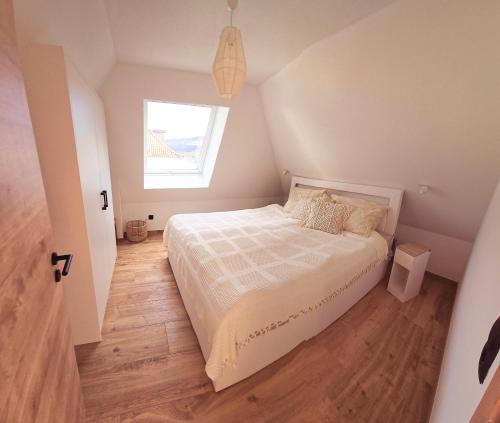 a small bedroom with a bed and a window at Ferienwohnung Glücksquelle in Bad Pyrmont