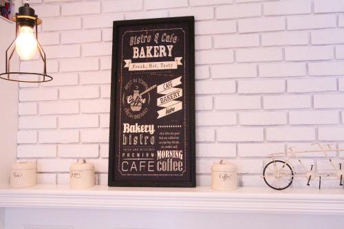 a chalkboard sign on a white shelf with candles at At Residence Suvarnabhumi Hotel in Lat Krabang