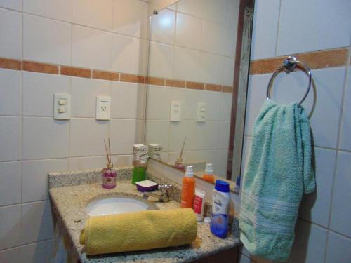 a bathroom with a sink and a mirror at Carnaval Inn Salvador in Salvador