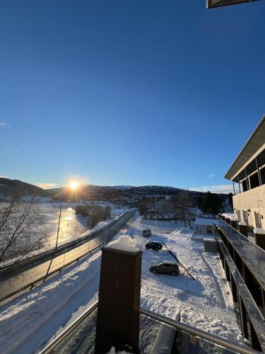 a view of a snow covered street with cars parked at Voss Apartment in Oppheim Resort, pool and view in Vossevangen