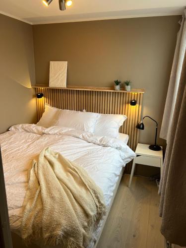 a bed with a blanket on it in a bedroom at Voss Apartment in Oppheim Resort, pool and view in Vossevangen