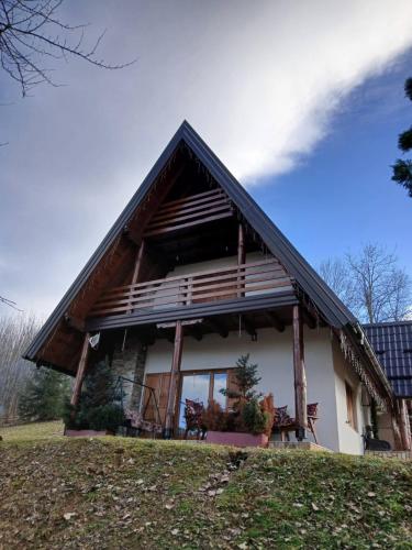 a large house with a gambrel roof at Forest house ALEKSANDAR in Srbac
